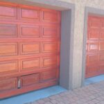 Two garage doors installed by Expert Garage Doors on a residential property.