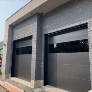 Black garage doors with windows installed by Expert Garage Doors.