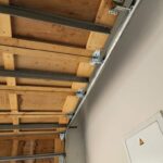 Garage door fully opened, revealing spacious garage, by Expert Garage Doors.