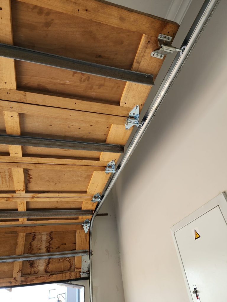 Garage door fully opened, revealing spacious garage, by Expert Garage Doors.