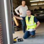 Expert Garage Doors technician discussing garage door work with happy homeowner.