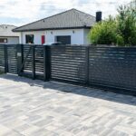 Black gate installed by Expert Garage Doors, ensuring secure access control.