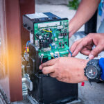A team of technicians from Expert Garage Doors repairing a gate motor.
