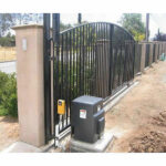 Black gate powered by motor, installed by Expert Garage Doors.
