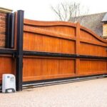 Wooden gate equipped with motor for automation by Expert Garage Doors.