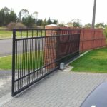 Black motorized gate installed by Expert Garage Doors.