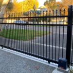 Black gate with motor automation by Expert Garage Doors.