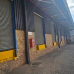 Industrial roller shutter doors installed in a warehouse by Expert Garage Doors.