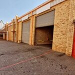 Heavy-duty roller shutter doors installed in a warehouse by Expert Garage Doors.