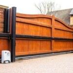 Wooden gate equipped with motor for automation by Expert Garage Doors.