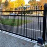 Black gate with motor automation by Expert Garage Doors.