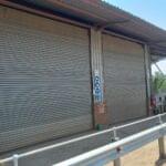 Heavy-duty roller shutter doors installed in a warehouse by Expert Garage Doors.