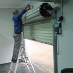 Expert Garage Doors technician repairing roller shutter doors.