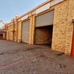 Heavy-duty roller shutter doors installed in a warehouse by Expert Garage Doors.